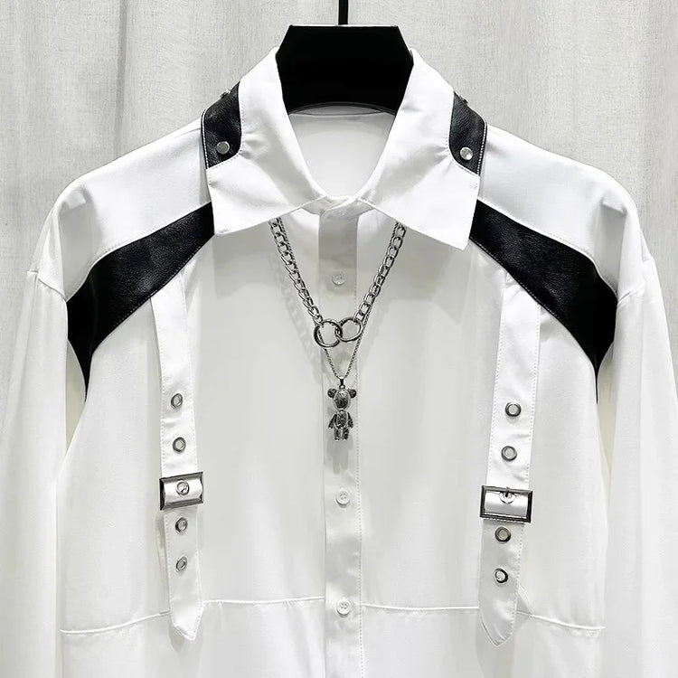 White long sleeve shirt with black faux leather shoulder accents and metal buckle details, modern streetwear style