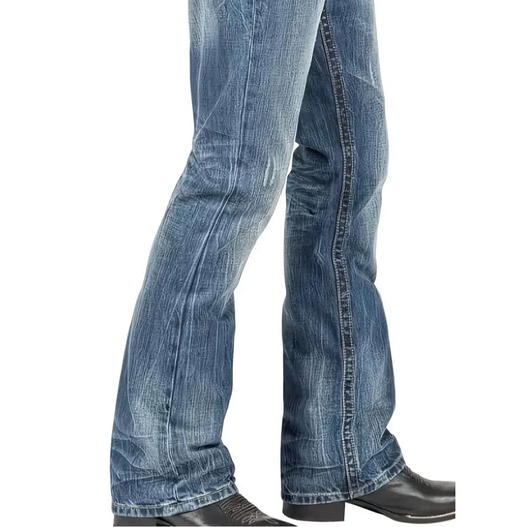 Blue distressed flared denim jeans with relaxed fit and textured wash, paired with black boots