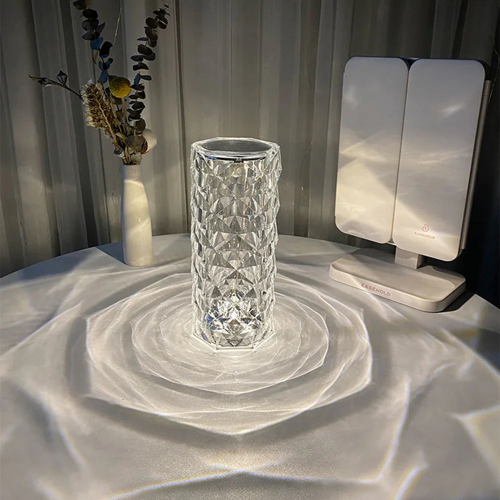 Modern geometric glass vase on table with decorative dried flowers and LED vanity mirror
