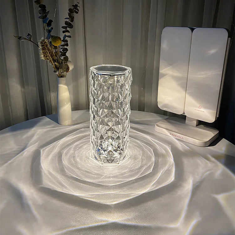 Modern geometric glass vase on table with decorative dried flowers and LED vanity mirror