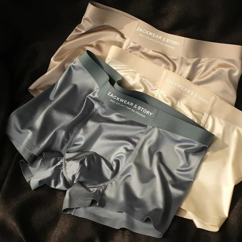 Three pairs of men's boxer briefs in beige and gray, satin finish, slim fit