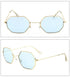 Geometric sunglasses with gold metal frame and light blue lenses, modern streetwear style