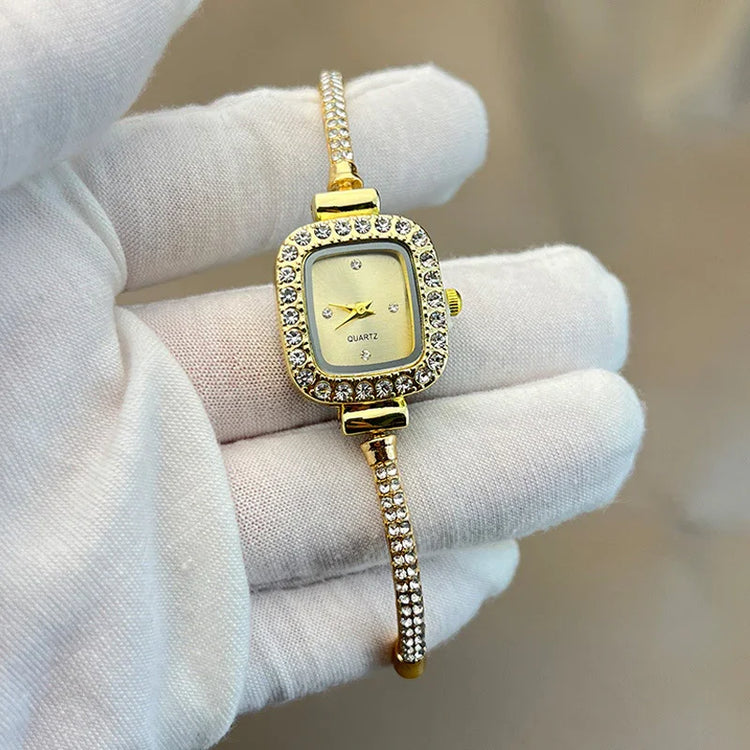 Gold-toned square ladies watch with crystal accents and slim bracelet strap, elegant fit