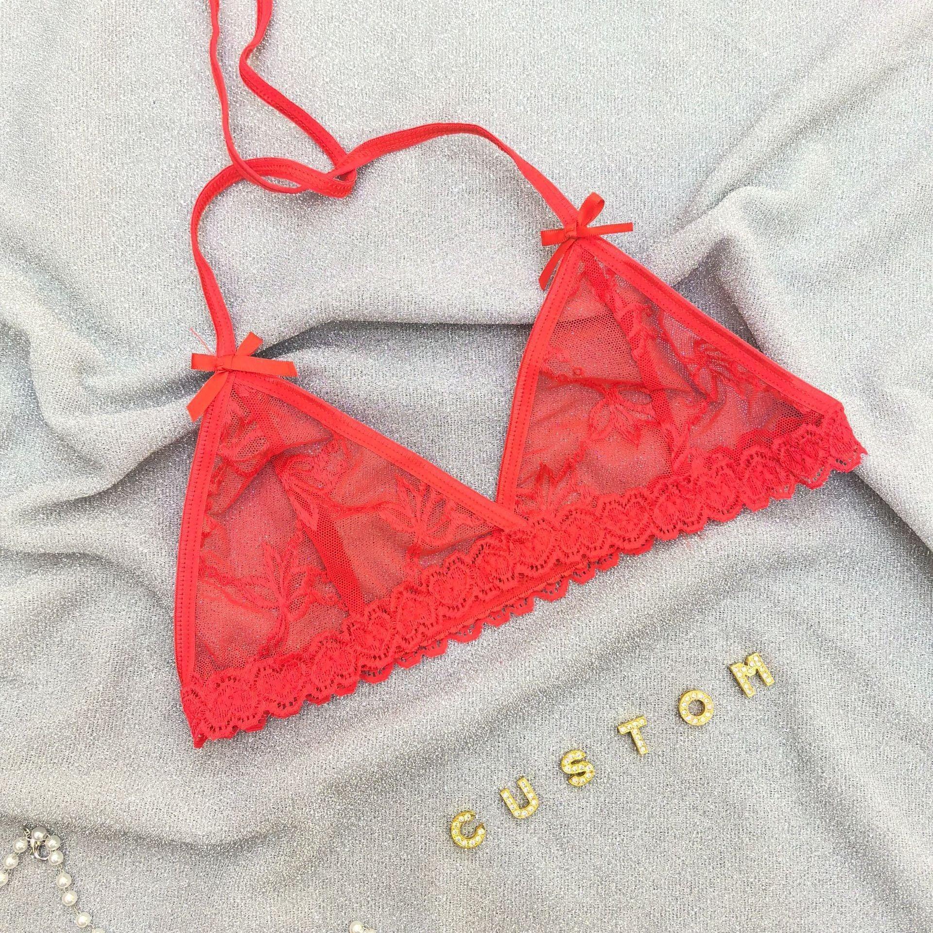 Red lace bralette with floral mesh, scalloped trim, and adjustable straps on soft fabric