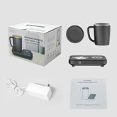 Black ceramic mug with matching lid, wireless charging base, power adapter, and user manual.