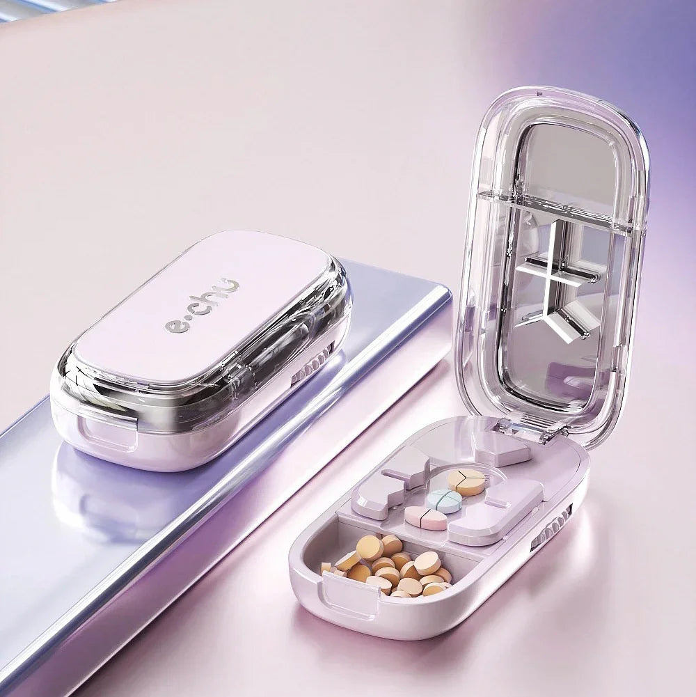 Modern pastel pill organizer case with transparent lid, multiple compartments, and assorted tablets