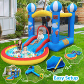 Kids playing in colorful inflatable bounce house with slide and pool in backyard.