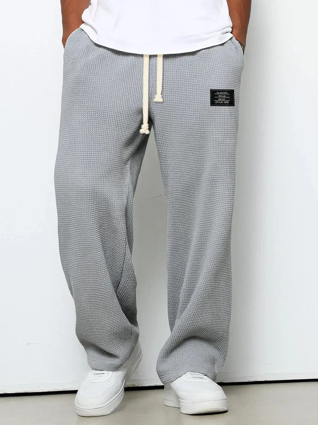 Loose fit gray waffle knit joggers with drawstring waist and patch detail, casual streetwear style