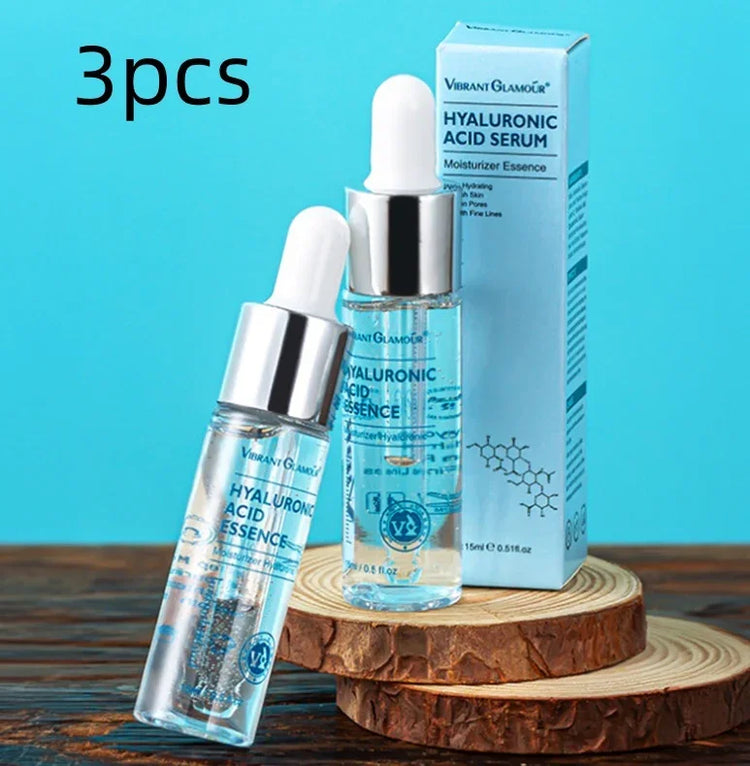 Clear glass serum bottles with silver caps and dropper tops, displayed on wooden rounds