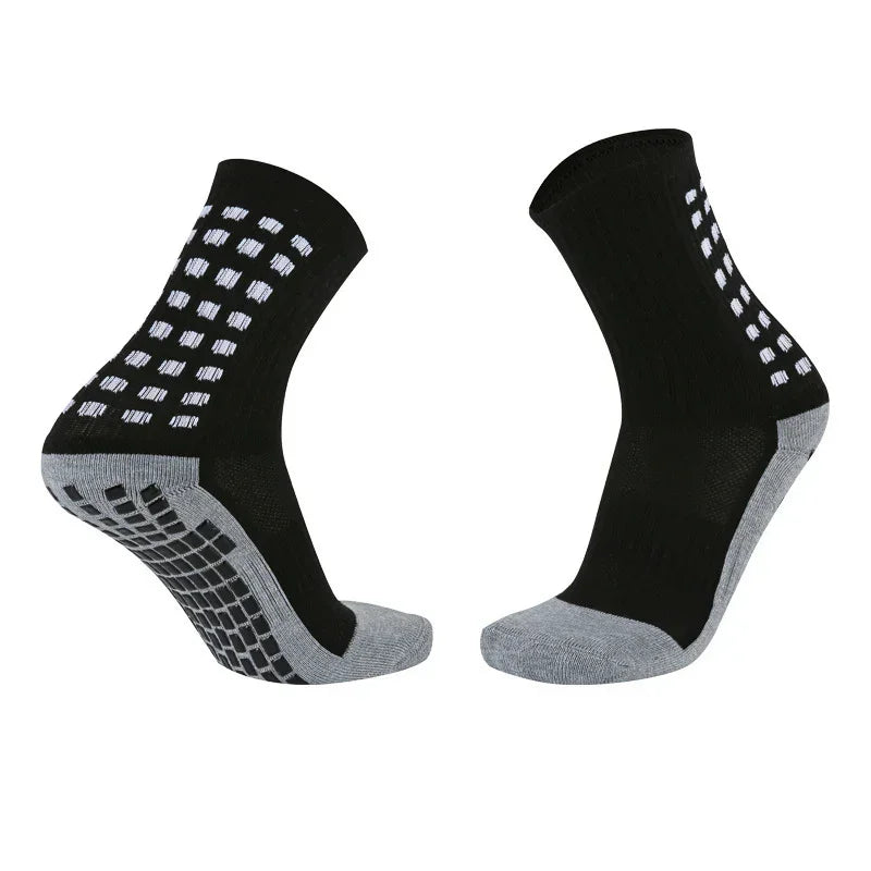 Black and gray crew socks with non-slip rubber grip soles and square pattern accents.