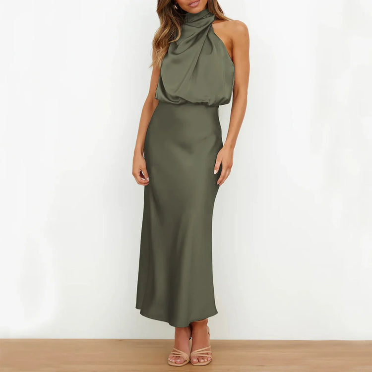 Woman wearing an olive green satin halter maxi dress with a draped neckline and slim fit.