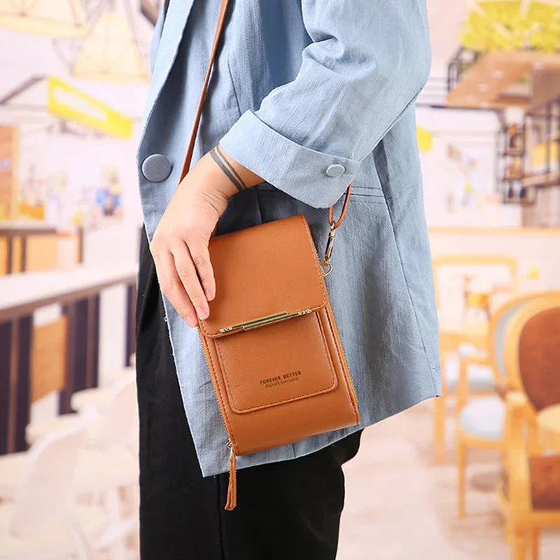 Person wearing a light blue loose-fit jacket and carrying a brown faux leather crossbody bag