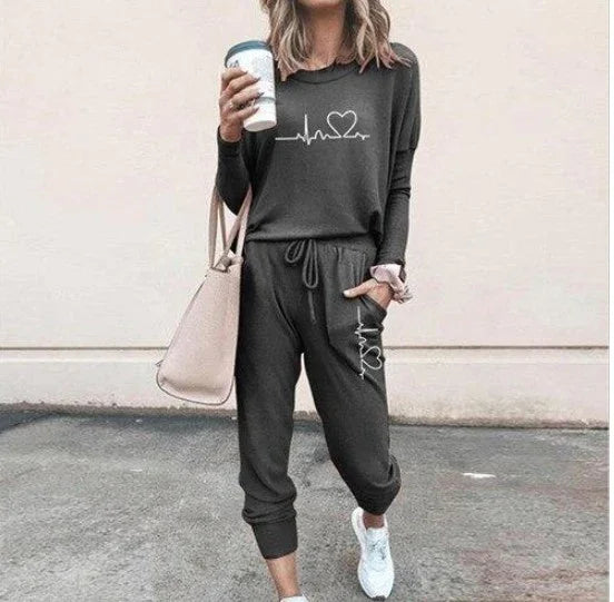 Woman wearing charcoal gray jogger set with heart graphic, relaxed fit, casual streetwear