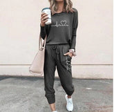 Woman wearing charcoal gray jogger set with heart graphic, relaxed fit, casual streetwear