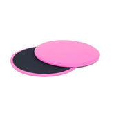 Pair of round pink and black exercise sliders with smooth and textured surfaces, fitness accessory
