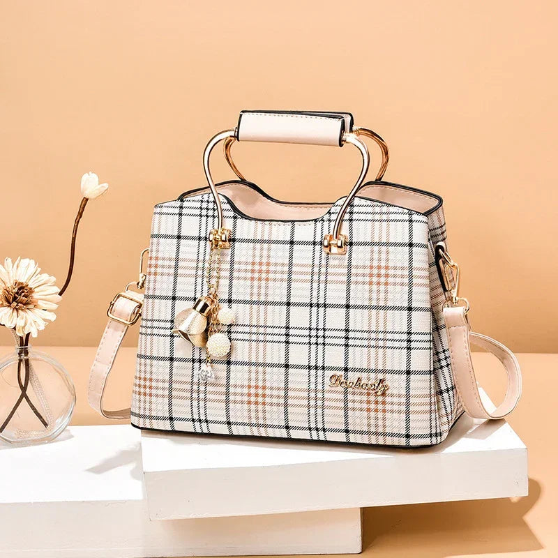 Plaid handbag with gold metal handles, beige and peach tones, structured fit, leather material