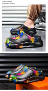 Black slip-on streetwear clogs with colorful paint splatter design, chunky sole, relaxed fit