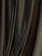 Draped black or dark brown satin fabric with a smooth, shiny streetwear style finish