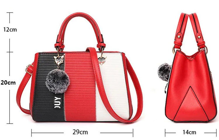 Colorblock handbag in red, black, and white faux leather with top handle, crossbody strap, and gray fur charm.