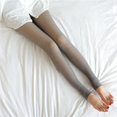 Sheer gray tights with a smooth finish, slim fit, styled with white shirt on bed