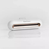 White and gold tech accessory with sleek, rounded design on a reflective surface