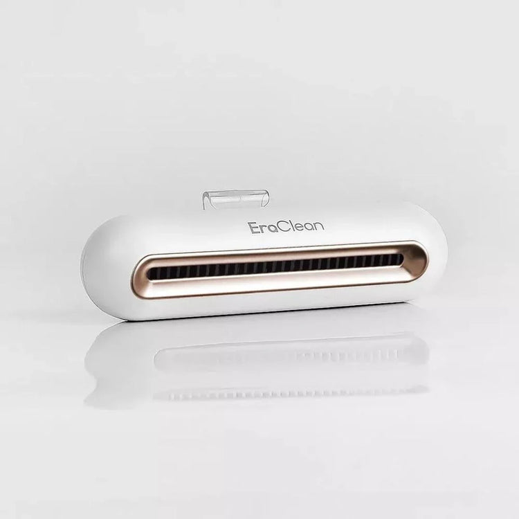 White and gold tech accessory with sleek, rounded design on a reflective surface