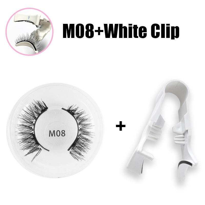 Black false eyelashes in round case with white plastic applicator clip