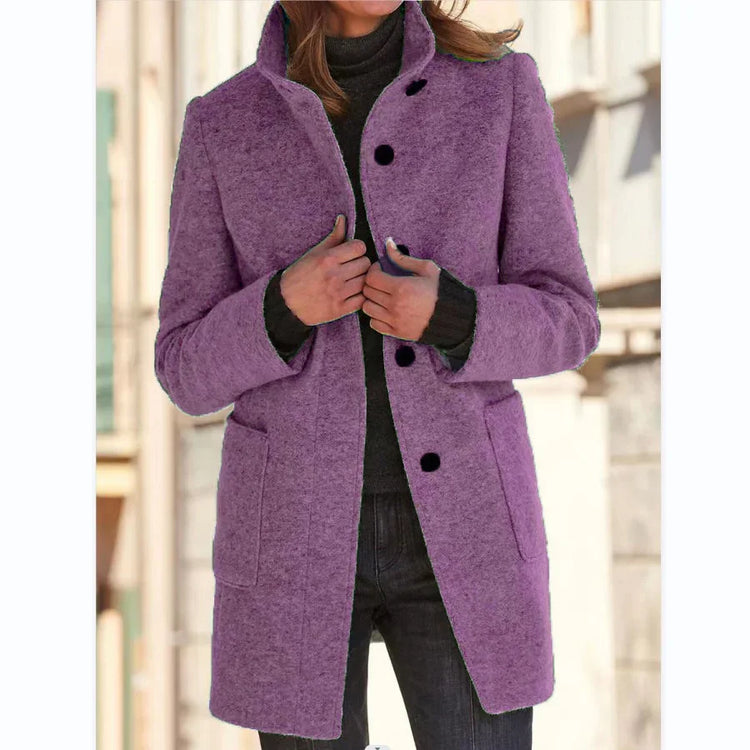 Woman wearing a tailored purple wool coat with black buttons and front pockets, casual fit
