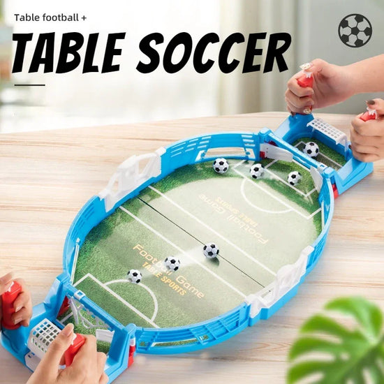 Mini tabletop soccer football game with blue plastic frame and small soccer balls, hands playing