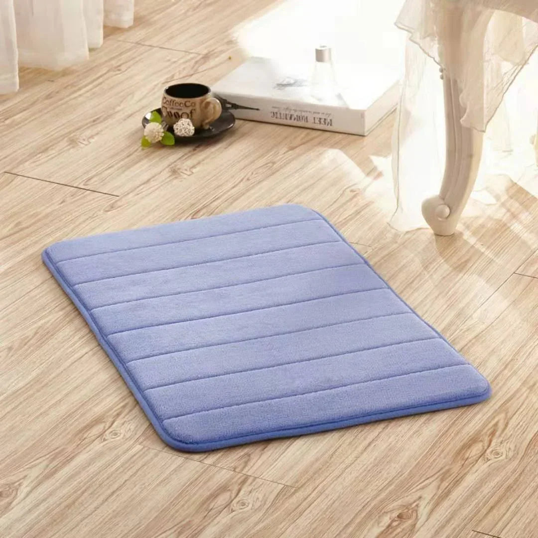 Soft light purple microfiber bath mat with quilted texture on wooden floor
