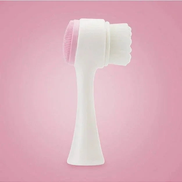 Dual-sided white and pink facial cleansing brush with soft bristles and silicone pad