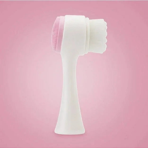 Dual-sided white and pink facial cleansing brush with soft bristles and silicone pad