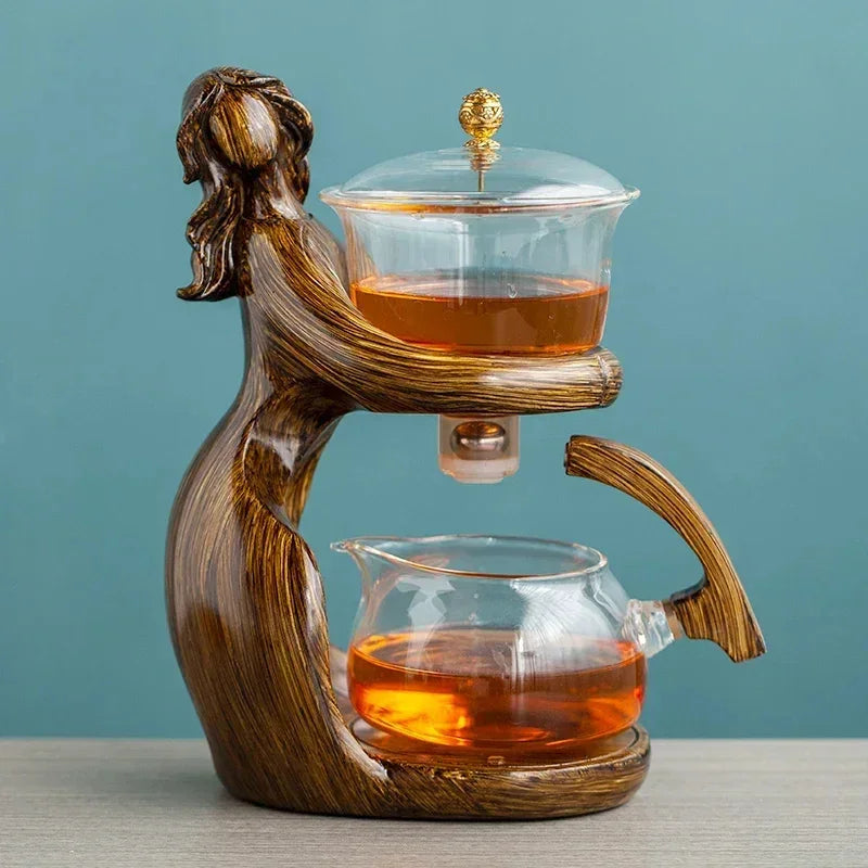 Artistic glass teapot set with wood-effect holder, two glass pots, and modern design.