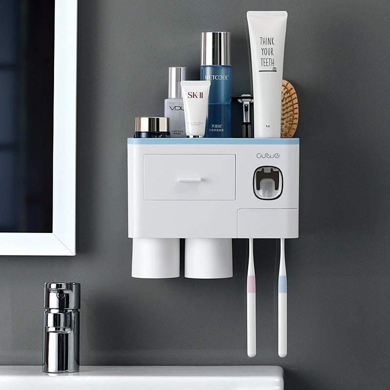 Wall-mounted white plastic bathroom organizer with cups, toothbrushes, and skincare bottles