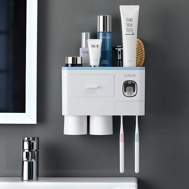 Wall-mounted white plastic bathroom organizer with cups, toothbrushes, and skincare bottles