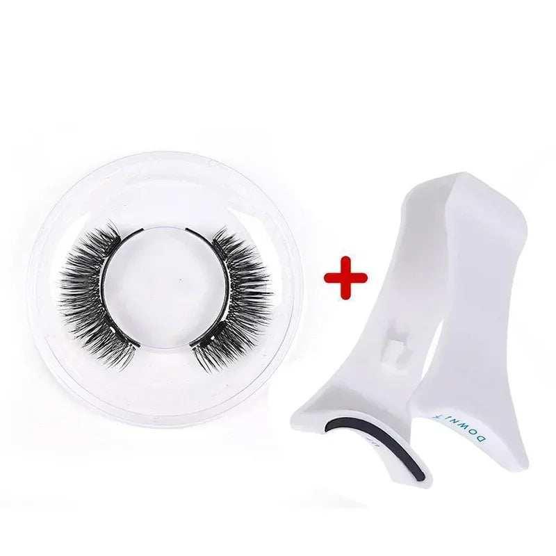 Black false eyelashes in clear round case with white plastic applicator tool