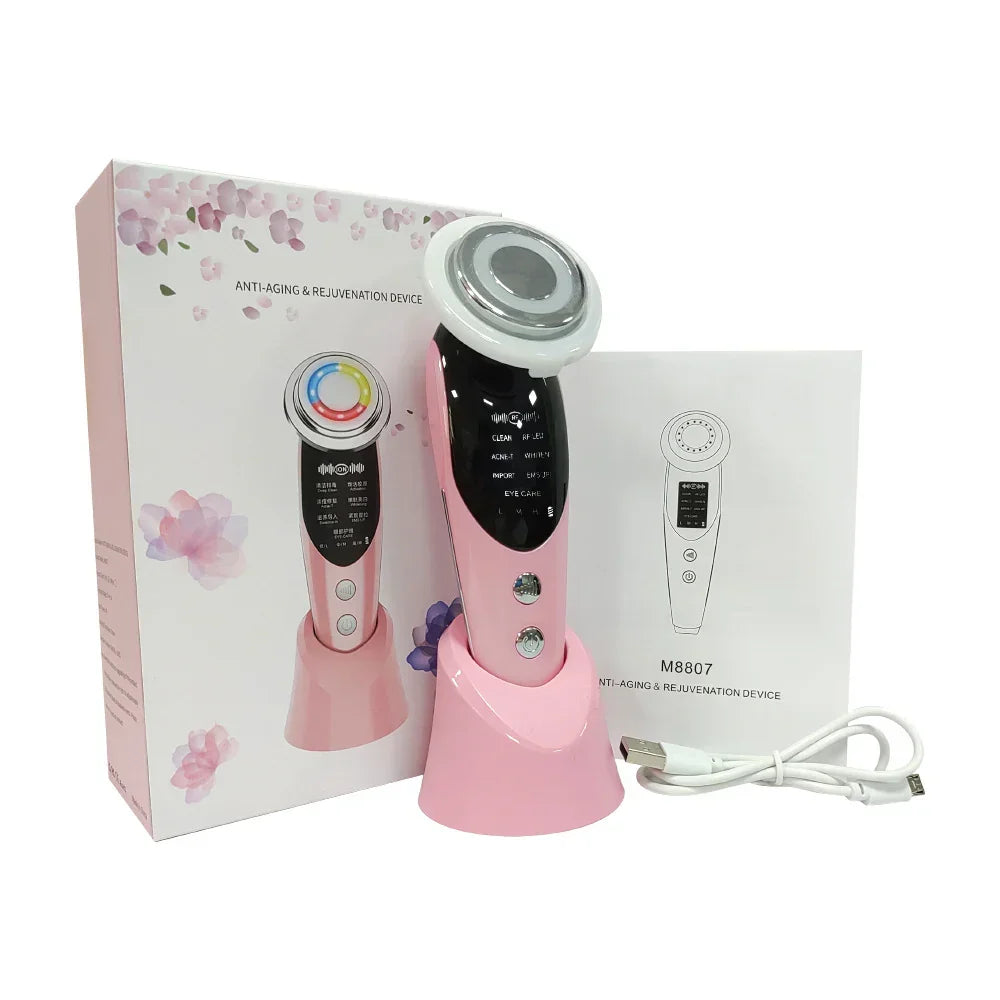 Pink handheld anti-aging facial device with charging stand, USB cable, and packaging.