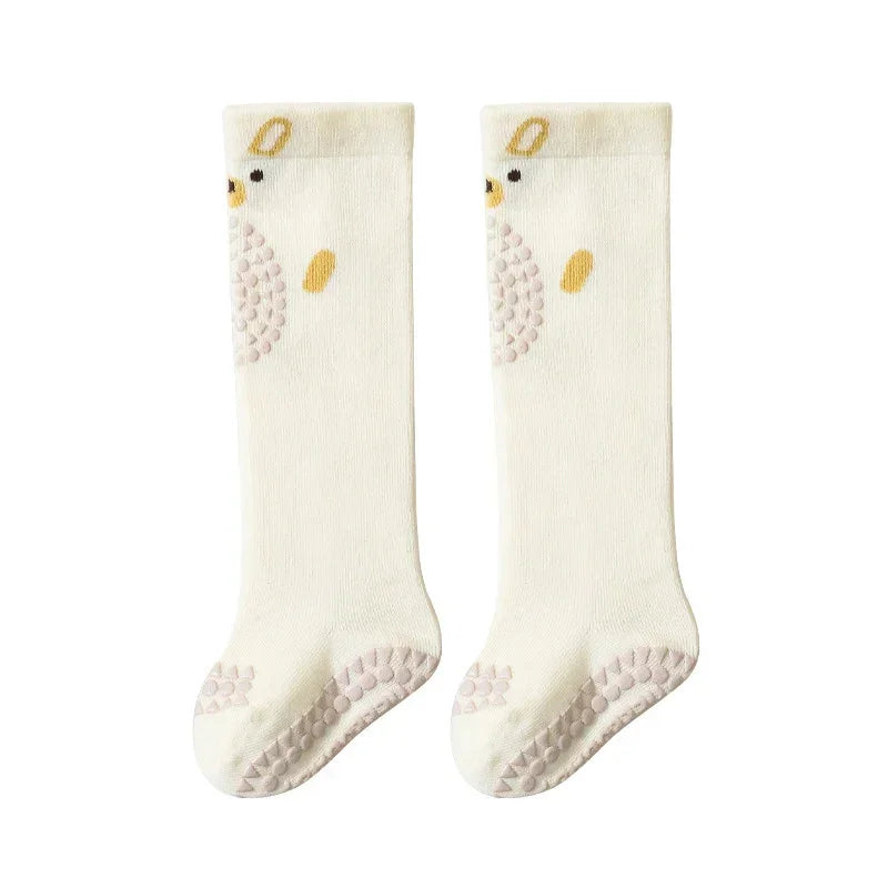 Cream knee-high socks with animal face design and non-slip grip soles, soft cotton material