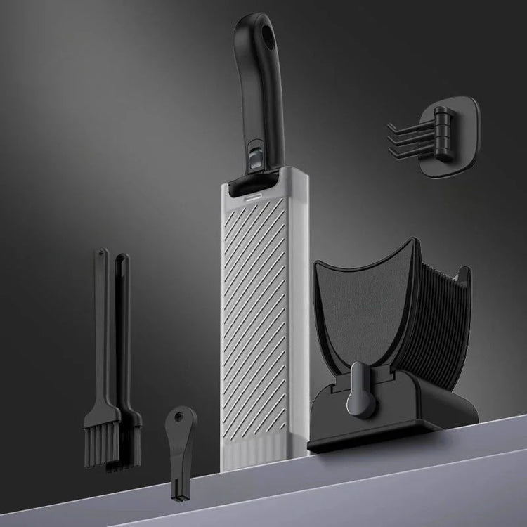 Modern kitchen utensil set with black and silver slicer, brushes, and holder on gray background