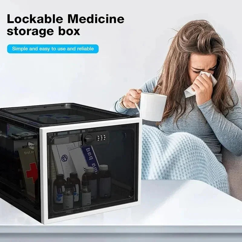 Woman in grey knit sweater with blanket, holding a mug and tissue, beside a lockable medicine storage box on a table.