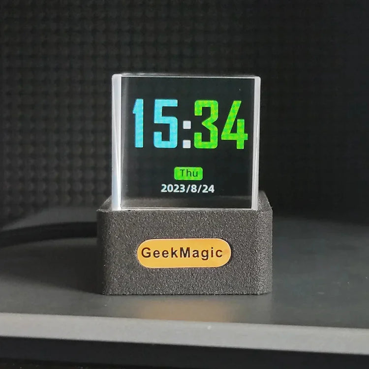 Modern transparent digital clock with colorful LED display and black rectangular base