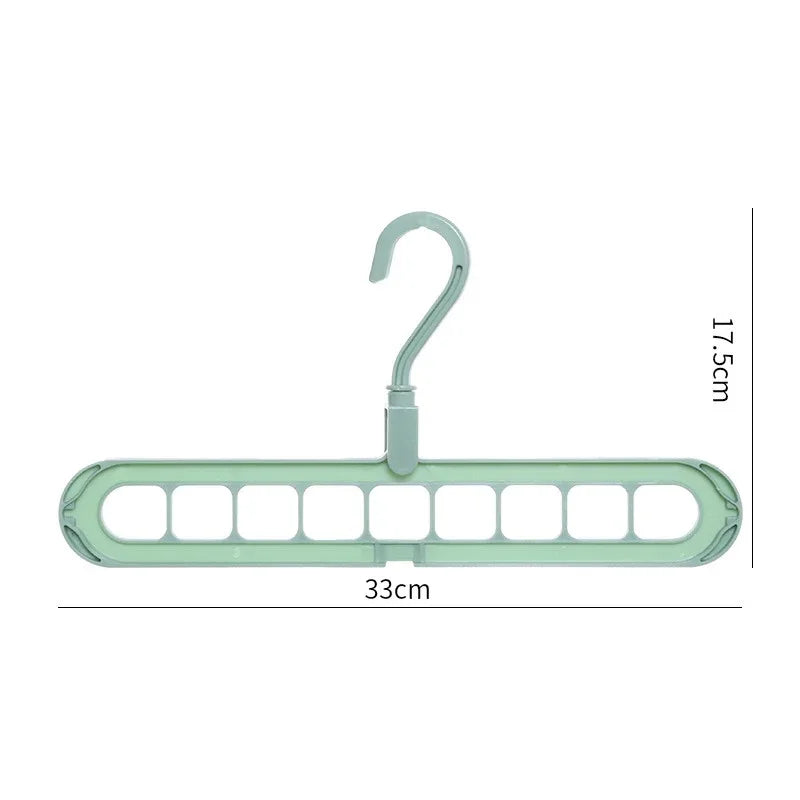 Green plastic multi-slot clothes hanger, 33cm wide, 17.5cm tall, for space-saving closet storage.