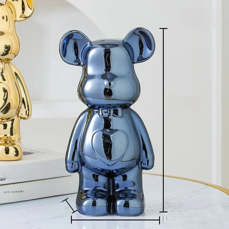 Metallic blue and gold bear-shaped decorative figurines with glossy finish on modern tabletop.