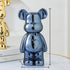 Metallic blue and gold bear-shaped decorative figurines with glossy finish on modern tabletop.