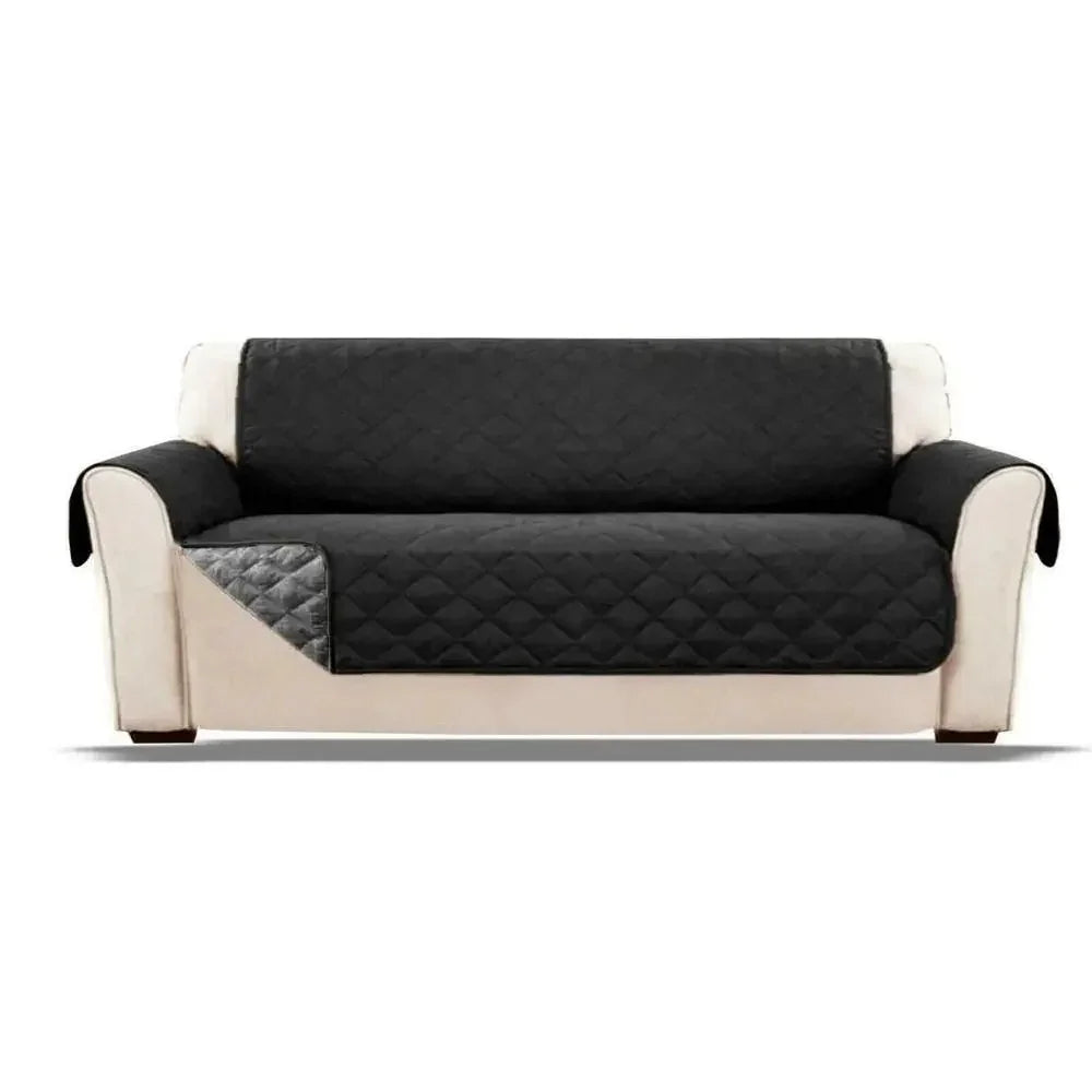 Black quilted sofa cover on beige upholstered couch, reversible, modern furniture protector