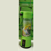 Green portable blender with clear plastic body and strap, compact design, fruit graphics inside