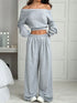 Woman wearing light gray off-shoulder crop top and wide-leg lounge pants set, relaxed fit