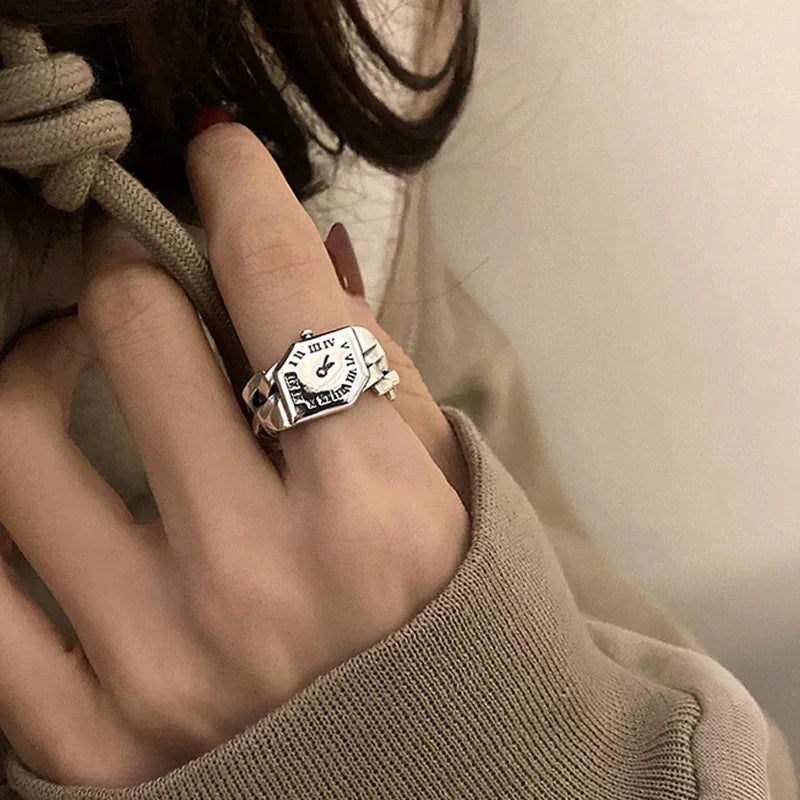 Beige oversized hoodie with relaxed fit, paired with a silver vintage watch face ring