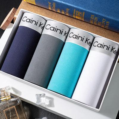 Set of four men's cotton boxer briefs in navy, grey, turquoise, and white colors with elastic waistbands.
