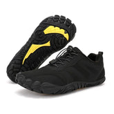 Black minimalist sneakers with yellow non-slip soles, lightweight fabric, modern athletic style
